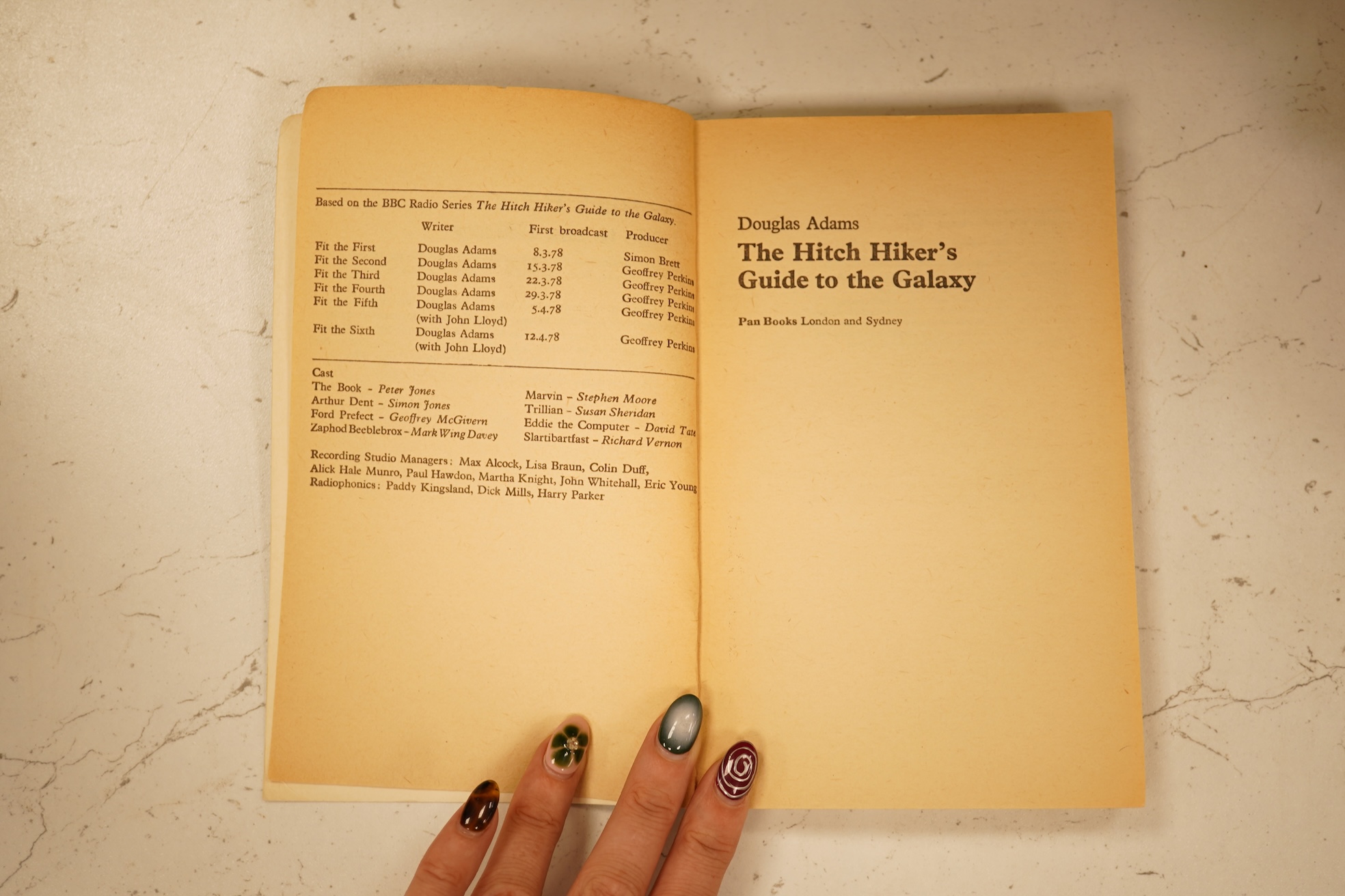 Adams, Douglas - The Hitch Hiker's Guide to the Galaxy. first edition, 2nd printing. half title/radio series leaf; paperback, sm. 8vo. Pan Books, 1979. *published same year as first and with a differently designed cover;
